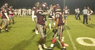 Oak Hall player celebrates with teammate