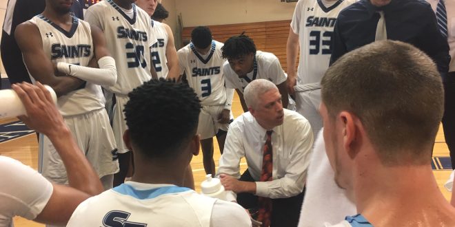 Chris Mowry leads huddle during timeout