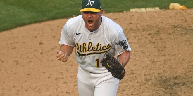 A's pitcher Liam Hendriks celebrates strikeout