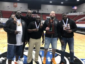 Hawthorne coaches pose with trophy