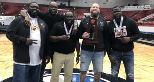 Hawthorne coaches pose with trophy