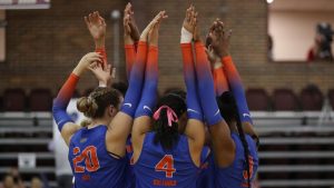 Gators Volleyball huddle on court