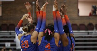 Gators Volleyball huddle on court