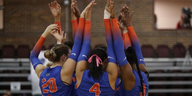 Gators Volleyball huddle on court
