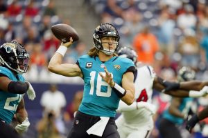 Trevor Lawrence throws the ball in Week 1 game against Houston
