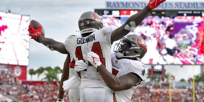 Buccaneers players chest bump after scoring
