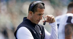 Cincinnati head coach Luke Fickell talks into his headset