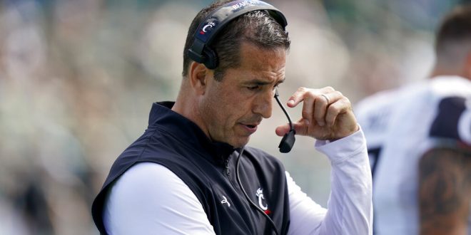 Cincinnati head coach Luke Fickell talks into his headset