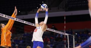 Florida volleyball setter sets the ball by the net