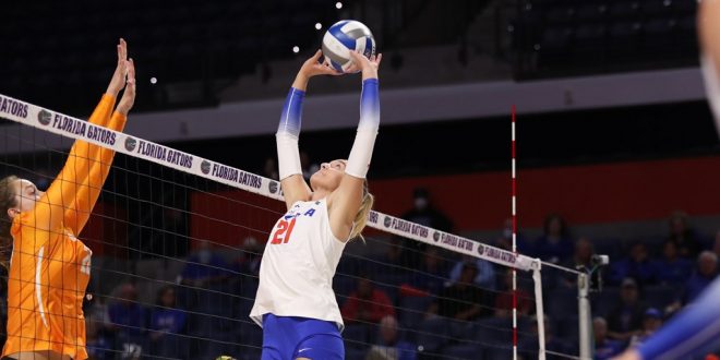 Florida volleyball setter sets the ball by the net