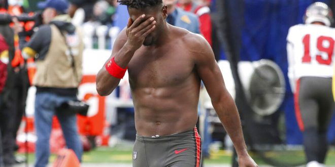 Shirtless Antonio Brown exits the field
