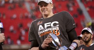 Joe Burrow holds AFC trophy