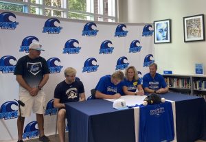 Drew Dawson signing his NLI with his coach and family.