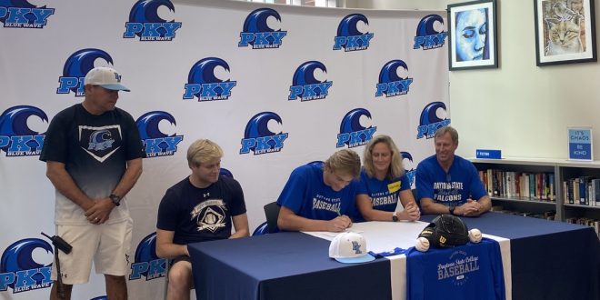 Drew Dawson signing his NLI with his coach and family.