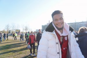 A Bayern Munich fan smiles as he checks out the NFL Fan Fest. Typically, instead of NFL football, Allianz Arena is home to Bayern Munich’s sold-out soccer games.