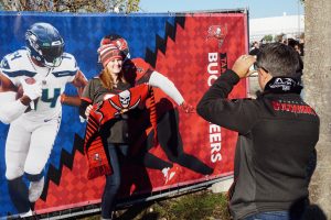A poses for a photo in front of the rivalry poster during the NFL Fan Fest. Scarves that are a norm for soccer games made their way to the Allianz Arena as an American football accessory.