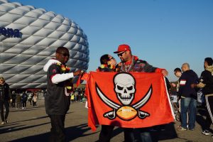 Buccaneers fans prepare for their team’s football game by cheering and chanting “Go Bucs” as fans from all over the world walk towards Allianz Arena. The Tampa Bay Buccaneers defeated the Seattle Seahawks in a first of its kind game in Munich, Germany.