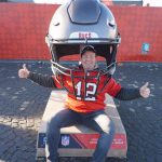 Fans traveled from around the world, many from Tampa, Florida, home of the Buccaneers. Fans lined up posing with their hometown or favorite teams inside of larger-than-life football helmets.