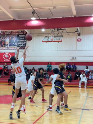 Natalie Chohan, number 10 for the Raiders, takes a jump shot.