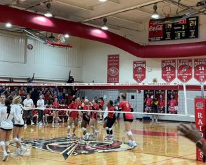 The Santa Fe Raiders celebrate. The scoreboard above them reads Home: 24, Away: 14.