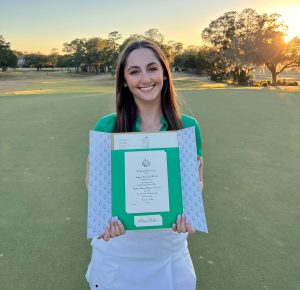 Maisie Filler poses with her invitation to the 2023 ASWA on Jan. 18. Photo courtesy of @GatorsGolf on Twitter.