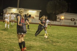 Senior Erin Coleman (18) dribbles up the field