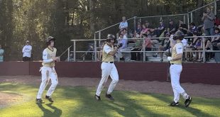 Jack Kuzmicki celebrating at home plate.