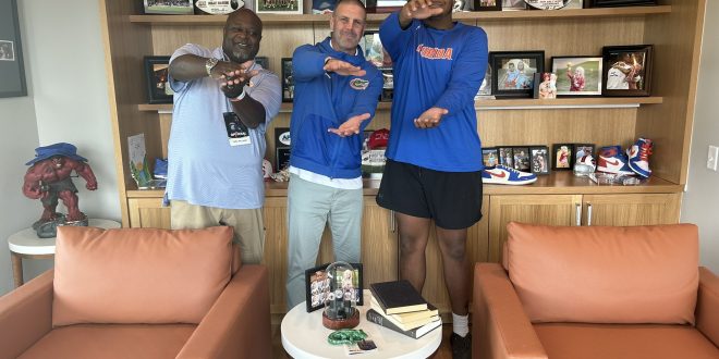 Gators head coach Billy Napier with new OT commit Mike Williams do the gator chomp in Napier's office.
