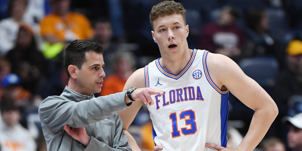  Florida Gators head coach Todd Golden talks with forward Aleks Szymczyk (13).