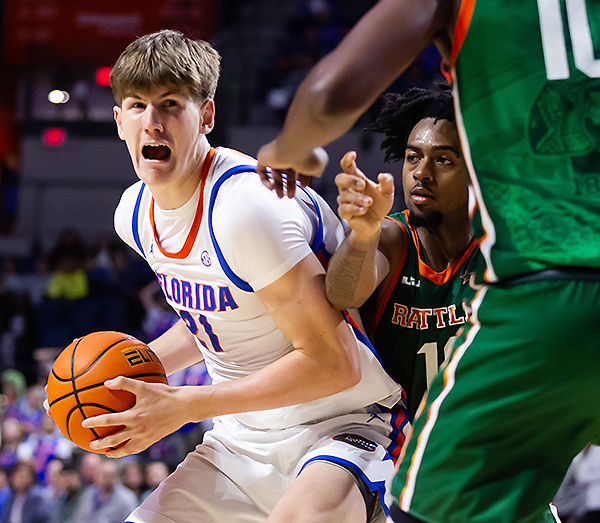 Florida Gators forward Alex Condon (21) powers his way to the basket against Florida A&M at the O'Connell Center in Gainesville, Florida.