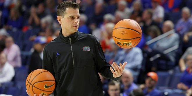 Florida men's basketball head coach Todd Golden juggles two basketballs before the Orange and Blue game at the Exactech Arena.