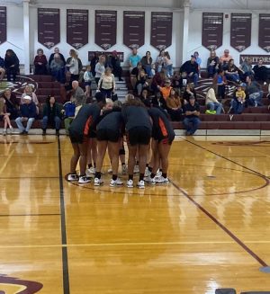 The Trenton Tigers girls basketball team gathers at half court Tuesday at Oak Hall.[Curan Ahern]