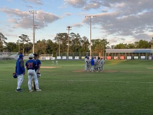 Saint Francis head coach, Ryan Brown, takes a mound visit to strategize with to his pitcher. [Raegan Churi]