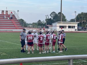 Lacrosse players huddled up at the beginning of the game