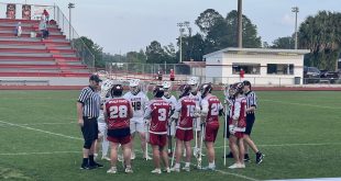 Lacrosse players huddled up at the beginning of the game