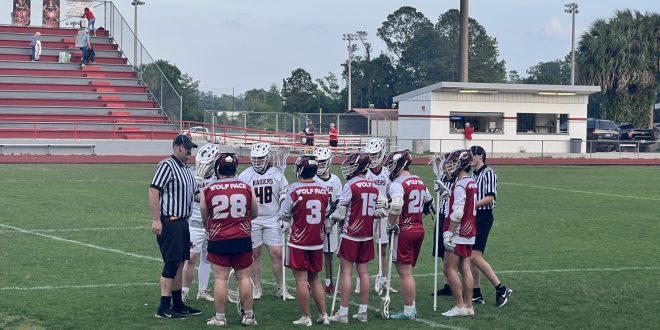 Lacrosse players huddled up at the beginning of the game