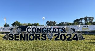 sign congratulating the Buchholz seniors in front of the field