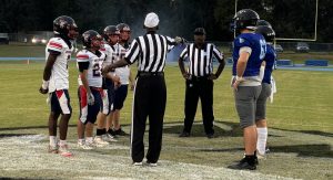 St. Francis Catholic and DeWitt Taylor meet at midfield for the pregame coinflip. [Charlie Jones]