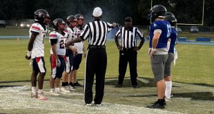 St. Francis Catholic and DeWitt Taylor meet at midfield for the pregame coinflip. [Charlie Jones]