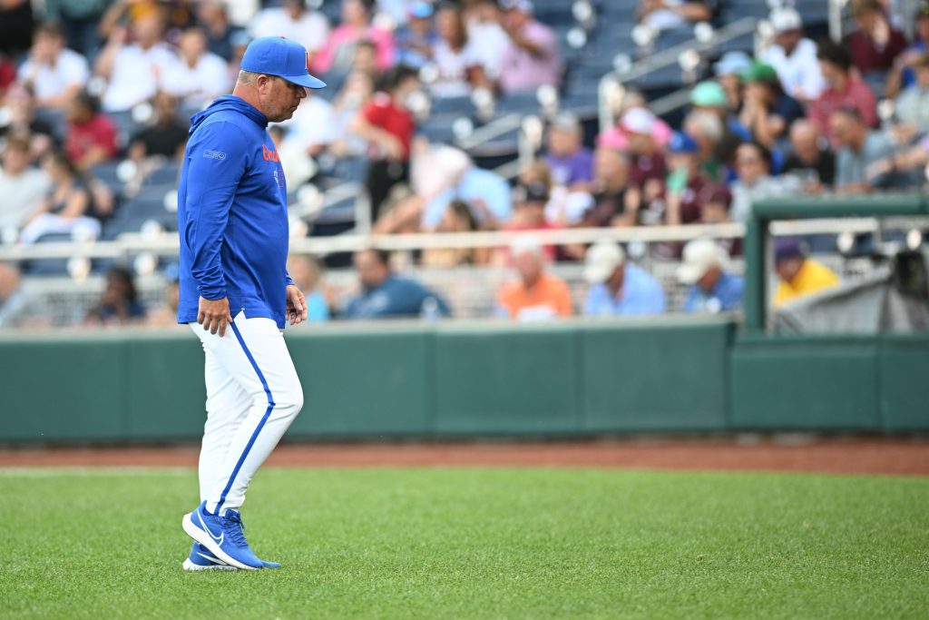 Florida Gators head coach Kevin O'Sullivan walks off the mound during the game against the Texas A&M Aggies during the first inning at Charles Schwab Field Omaha. Mandatory Credit: Steven Branscombe-USA TODAY Sports