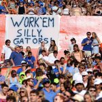 Florida fans tape a sign to the wall of Ben Hill Griffin Stadium during the Gators’ game against Mississippi State at Ben Hill Griffin Stadium in Gainesville, Fla., Saturday night, Oct. 18, 2025.