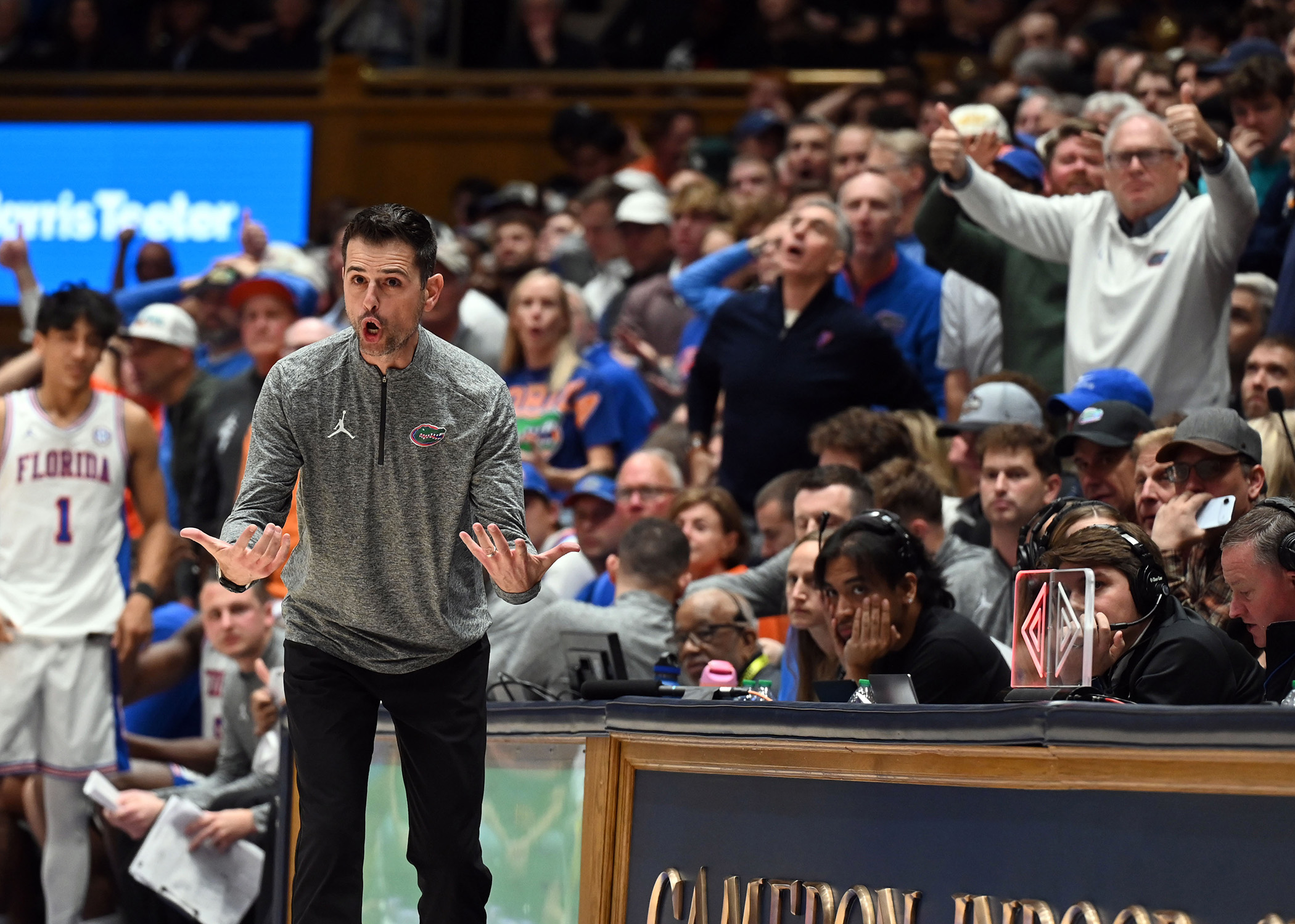 Coach Todd Golden screams as crowd cheers during the Gators loss to Duke.