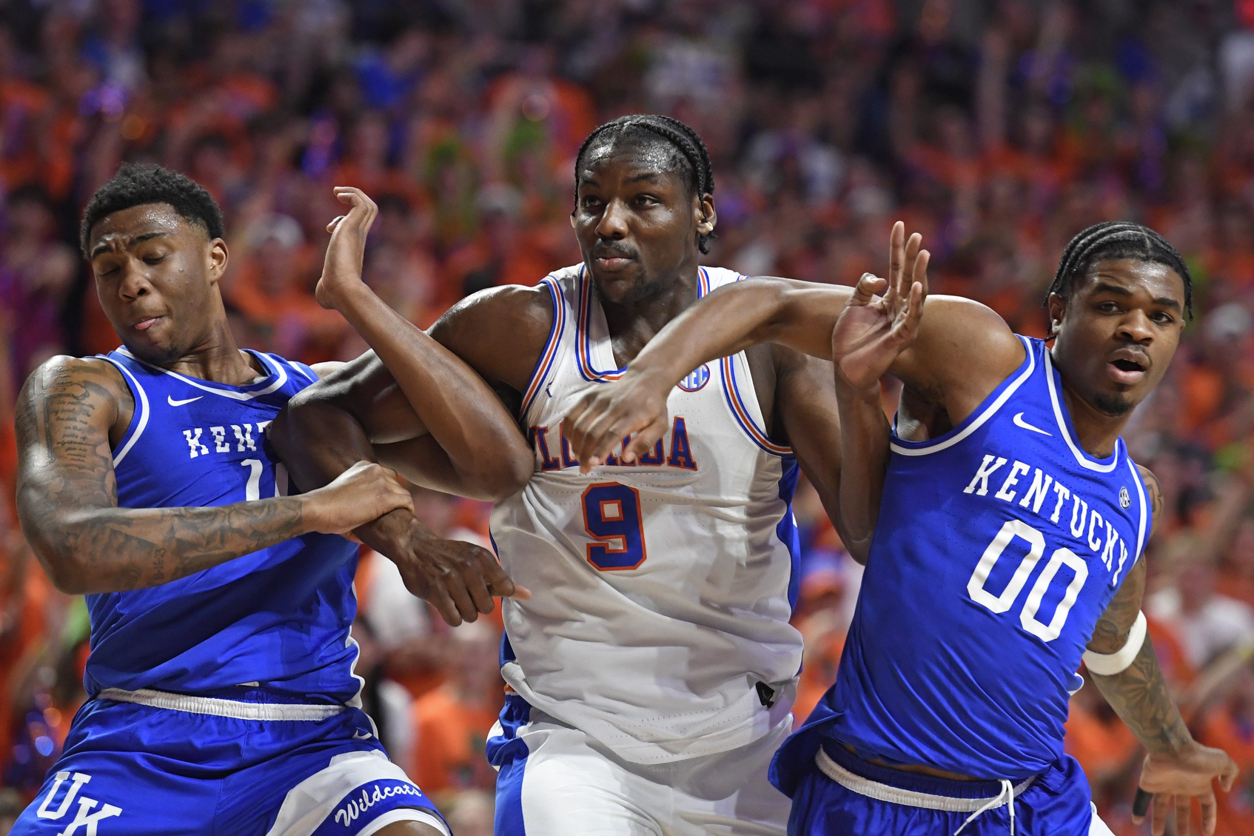 Florida center Rueben Chinyelu (9) is boxed out by Kentucky guard Otega Oweh (0) and forward Brandon Garrison (10) as the Florida Gators face the Kentucky Wildcats at the Stephen C. O’Connell Center on Saturday, Feb. 14, 2026, in Gainesville, Fla.