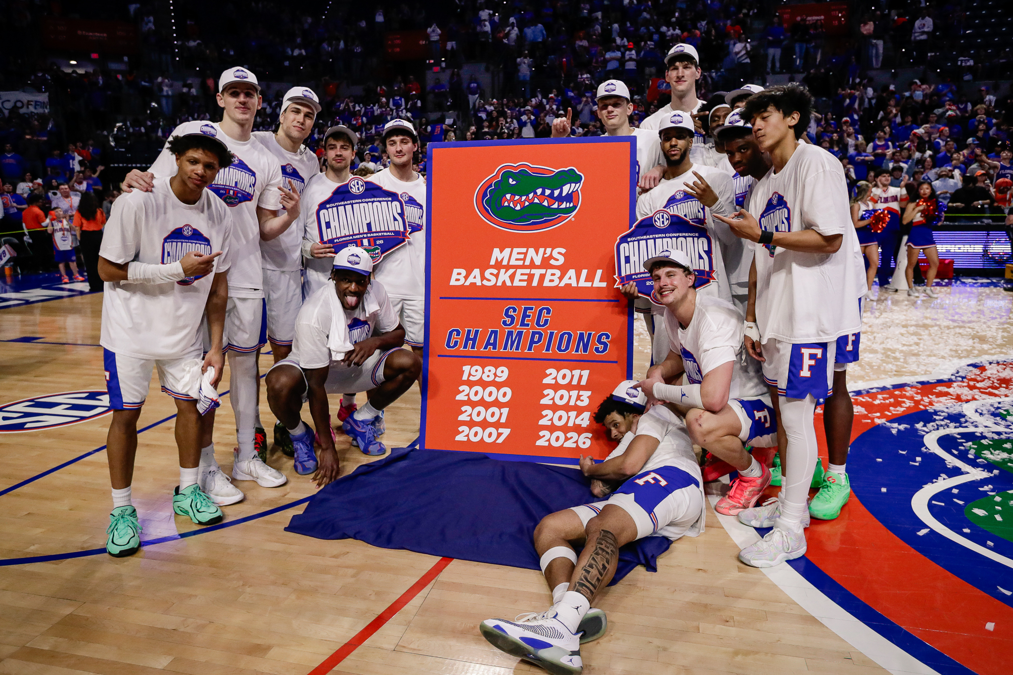 Florida Gators players pose for a team photo while celebrating the SEC regular season championship following the game Saturday against the Arkansas Razorbacks at Exactech Arena at the Stephen C. O'Connell Center.
