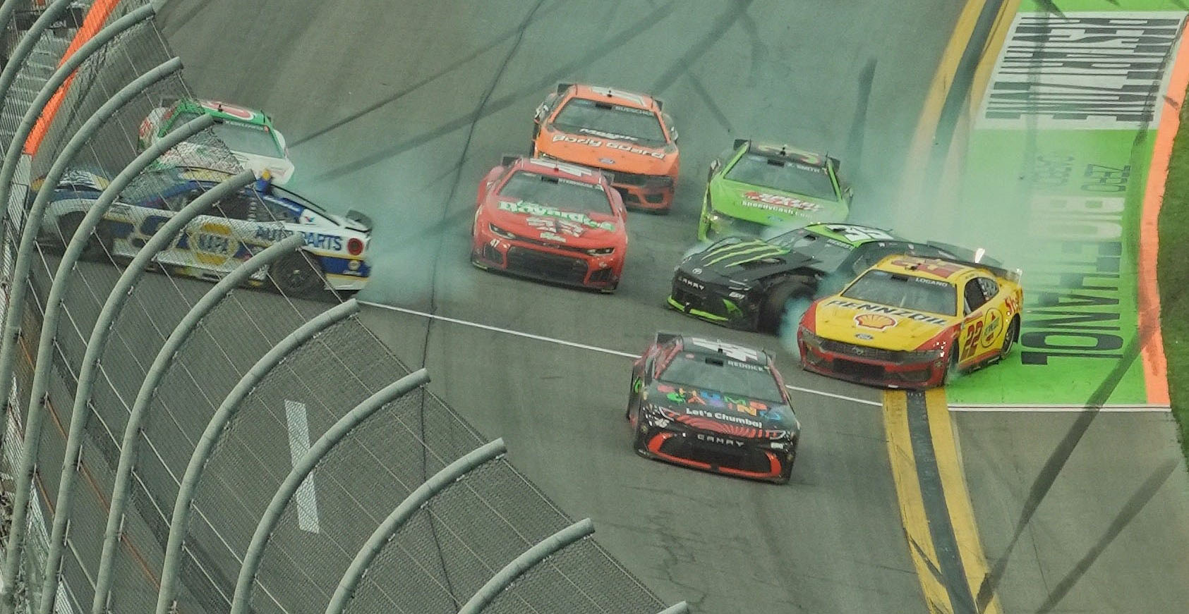 Tyler Reddick (center) survived the last-lap carnage at Daytona International Speedway to earn his first career Daytona 500 victory.
