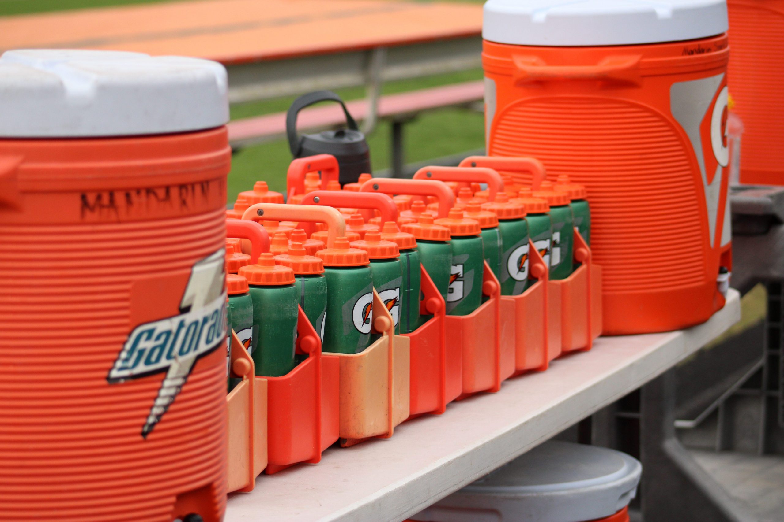 Gatorade sports drink coolers and bottles are lined up along the Mandarin High School bench during a high school football game against Creekside in Jacksonville, Florida, on September 23, 2022.