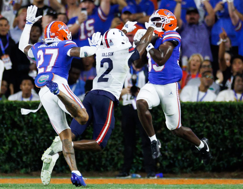 Sep 5, 2026; Gainesville, Florida, USA; Florida Gators safety DJ Coleman (33) intercepts a pass over Florida Atlantic Owls wide receiver Kelby Valsin (2) during the first half at Ben Hill Griffin Stadium.