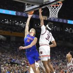 Florida forward Thomas Haugh (10) floats the ball up against Auburn forward Chaney Johnson (31) as the Florida Gators face the Auburn Tigers on Saturday, April 5, 2025, at the Alamodome in San Antonio, Texas. (Matthew Lewis/WRUF)