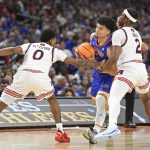 Florida guard Walter Clayton Jr. (1) is fouled by Auburn guards Tahaad Pettiford (0) and Denver Jones (2) as the Florida Gators face the Auburn Tigers on Saturday, April 5, 2025, at the Alamodome in San Antonio, Texas. (Matthew Lewis/WRUF)