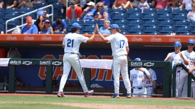 Caden McDonald (left) and Russell Sandefer (right) high-five each other on their way back to the dugout at the end of the sixth inning. (Photo by Ryan Scarane/WRUF)
